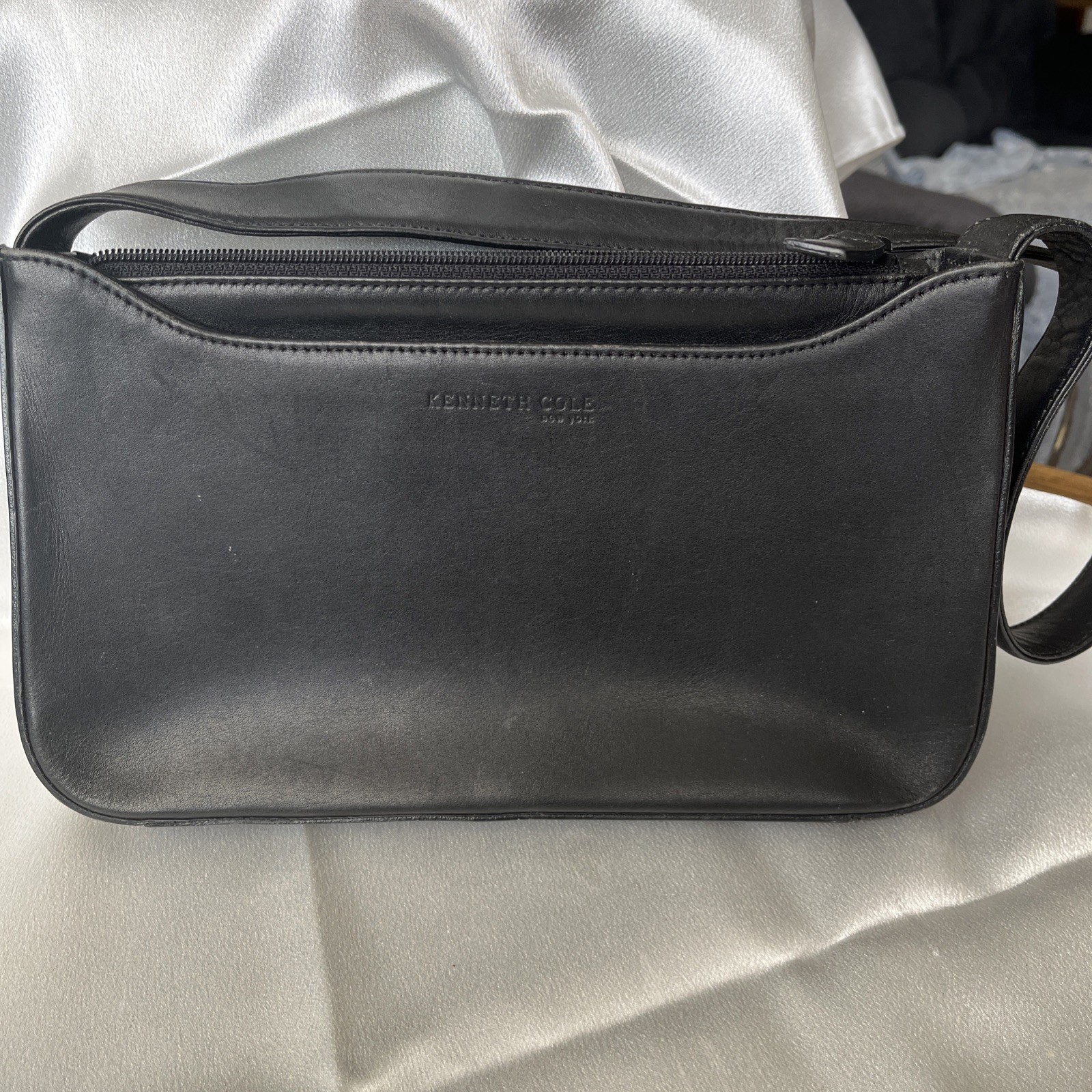 Kenneth Cole Black leather shoulder bag. Zip closure, front and back pockets