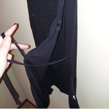 black sleeveless top with cut out strap accents and tie closure