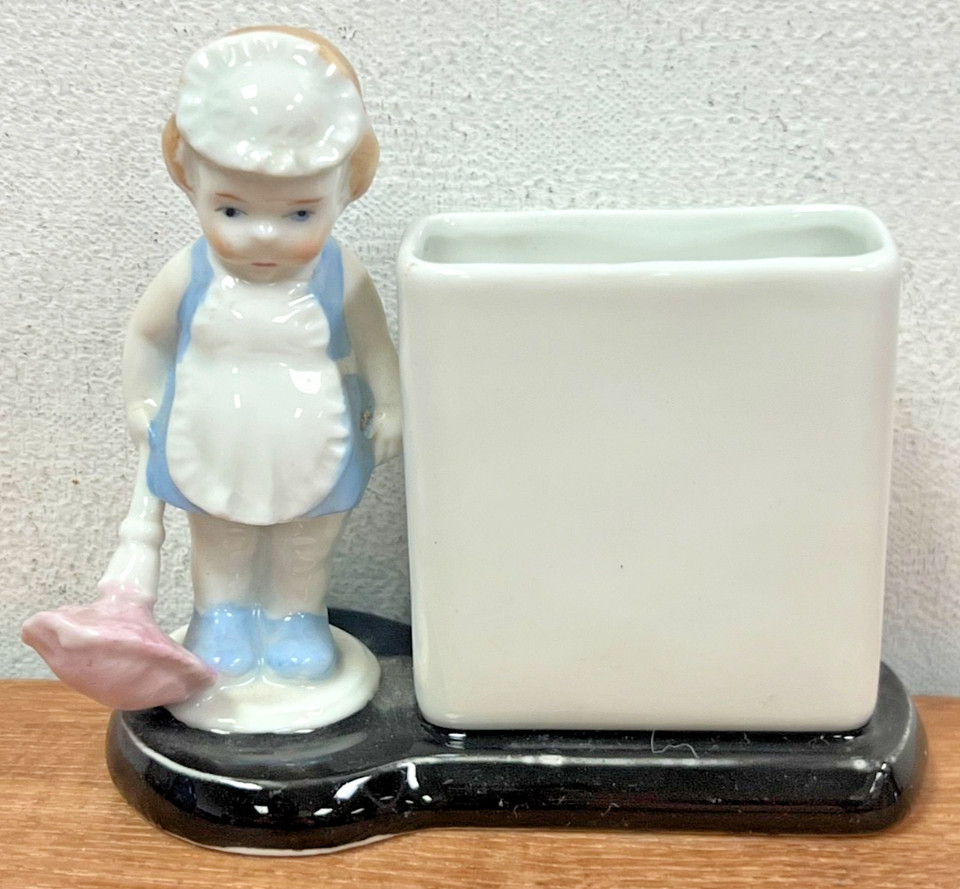 Delicate German porcelain toothpick holder shaped like a tiny baby maid — the kind of oddly charming antique that collectors hunt for.