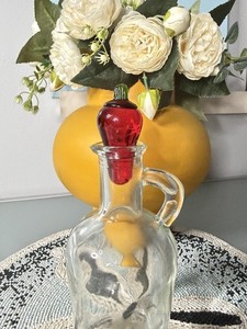 Vintage glass bottle with red chili glass stopper handle and pour spout