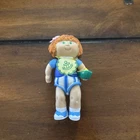 vintage Cabbage Patch Kids poseable figure Girl Holding A Ship With A Bib On