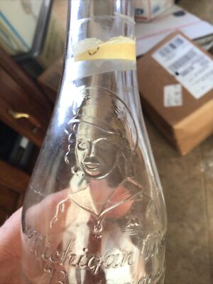 MICHIGAN MADE BEVERAGES MUSKEGON MI SODA BOTTLE 1950 EMBOSSED WOMAN FACE 