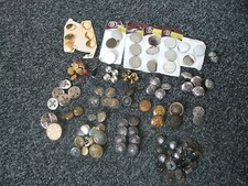 Bundle of various buttons some metal and some plastic that look like metal. 