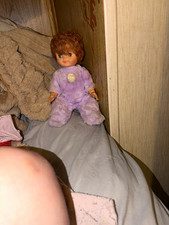 Soft Body Girl Baby Doll Curly Brown Hair Brown Eyes Light Skin Purple Outfit