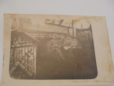 Postcard 2 soldiers, floor, newspaper, wooden houses occupied 14.6.17