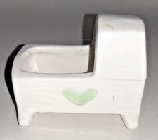 ceramic bassinet with green heart