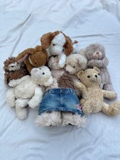 Collection of stuffed animals like bears, dogs, bunnies, and owls