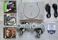 Playstation 1 Package..2 Controllers..Memory Card..3 Games