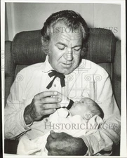 1967 Press Photo Actor Forrest Tucker feeds newborn son at Hollywood set