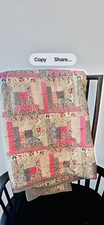 Beautiful quilt with colorful fabric featuring floral and patchwork designs
