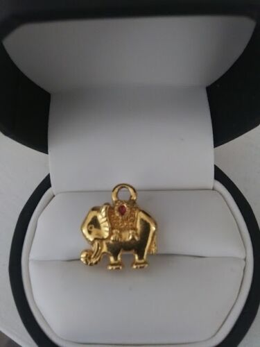 Ceremonial enamel elephant pendant gold in color