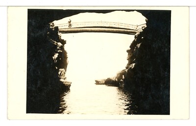 RPPC 1927 - 1940's Person on a Footbridge Over Water Outside a Cave Postcard