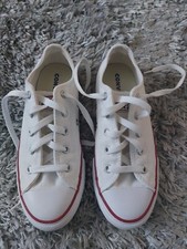 Image of white converse size 2.5 new (tiny pink mark shown in pic)