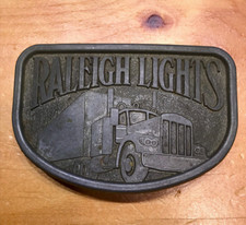 VINTAGE COLLECTIBLE RALEIGH LIGHTS TRUCKING CO BELT BUCKLE W/BIG RIG SEMI TRUCK