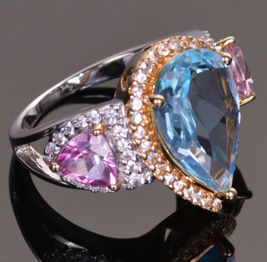 Featuring a Pear-Shaped 7.18CT Swiss Blue Topaz, Two Pink Ruby & White CZ Ring - Image 3 of 4
