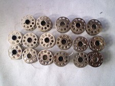 Lot of 17 Metal Sewing Machine Bobbins 15 are 10 holes 2 are 7 holes