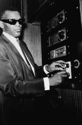 Musician Ray Charles adjusting the dials of a control panel 1961 Old Photo