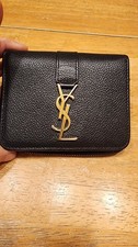 Saint Laurent YSL  Cassandre compact wallet in black grained leather.