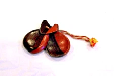 Two-tone wooden castanets on wool cord