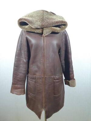 women's warm sheepskin coat made of genuine fur. Stylish long coat with hood