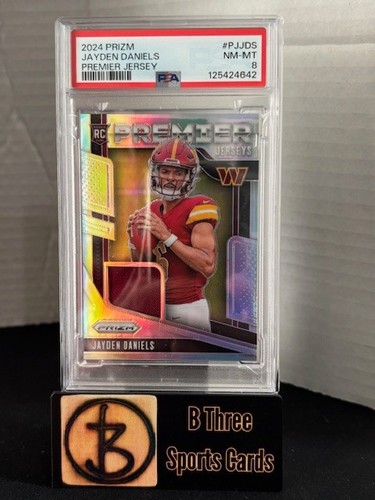 JAYDEN DANIELS 2024 Prizm #PJJDS Premier Jersey RC Commanders PSA 8 NM-MT A1044 - Picture 1 of 3