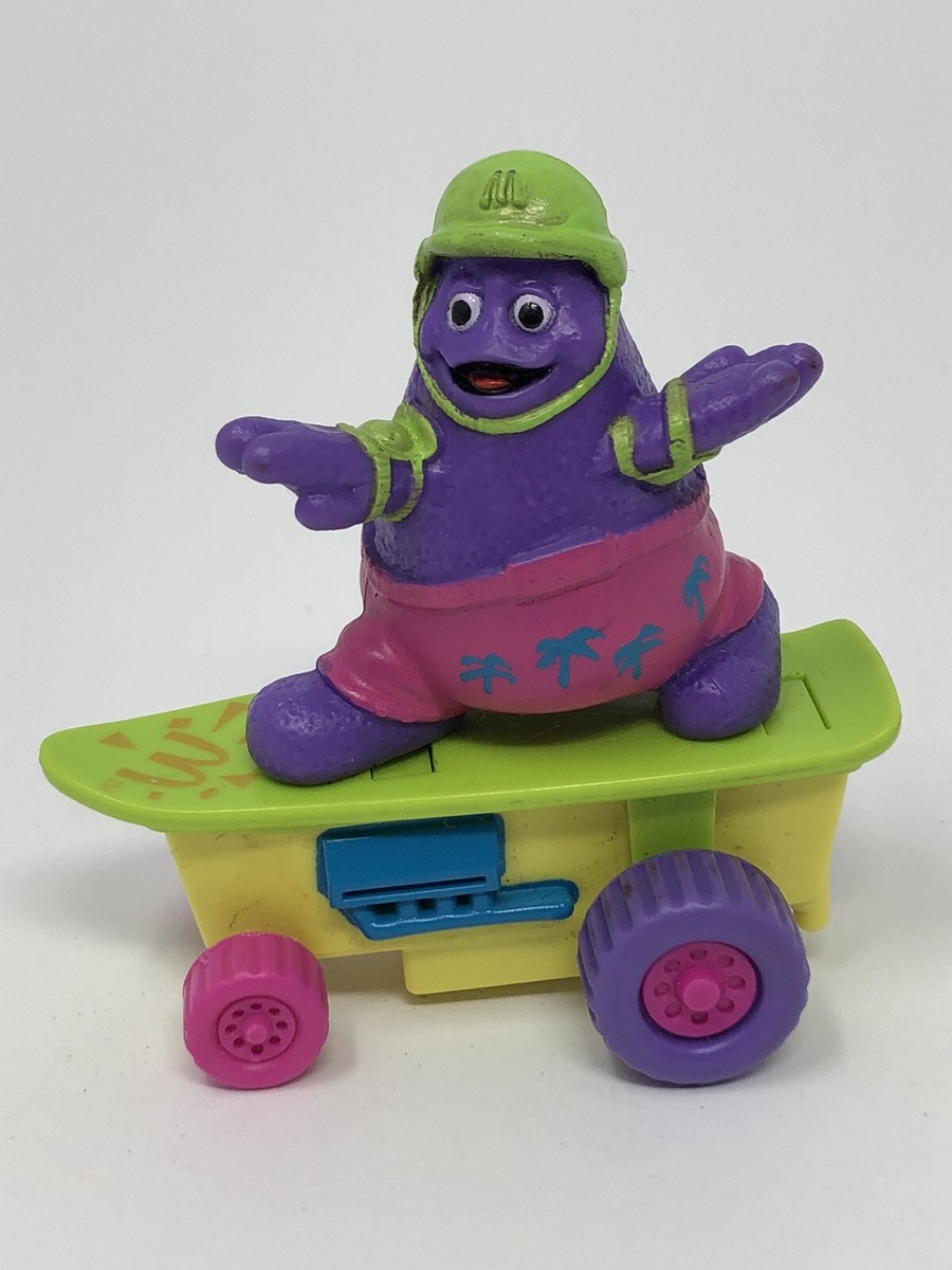 McDonalds Grimace on a Skateboard Pink Shorts Green Helmet Happy