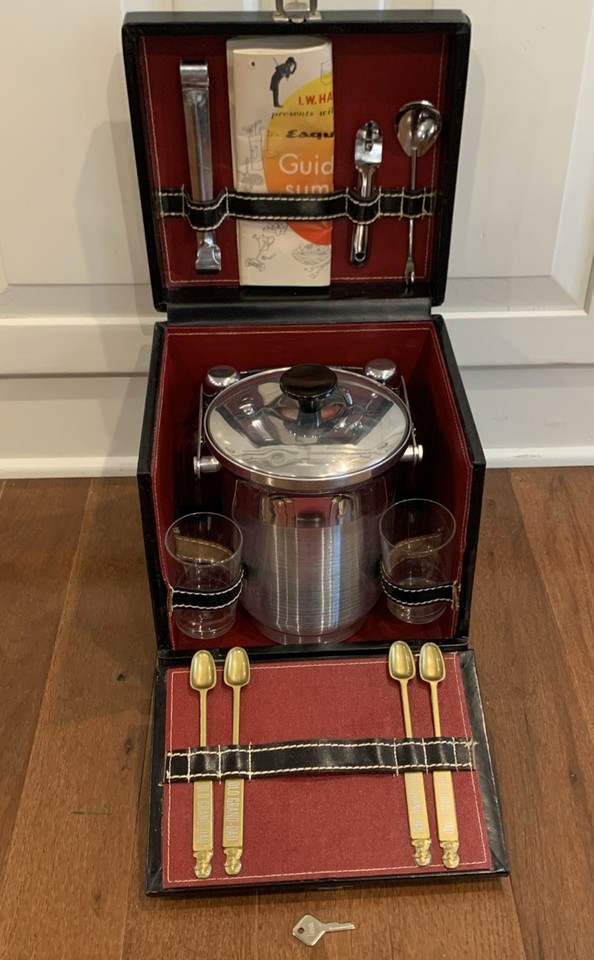 A complete 1950s–60s portable travel cocktail bar in a caddy box — the ultimate mid-century gentleman's kit for drinking in style anywhere.