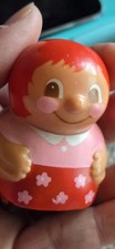 vintage roly-poly toy, specifically a Soviet-era "Nevalyashka" tumbler doll.