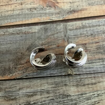 Signed Monet comma shaped silver tone clip on earrings 