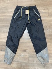 Pantaloni Nike Windrunner Uomo M Foderati Tessuto Nero DX0653-014 Regular Fit Track