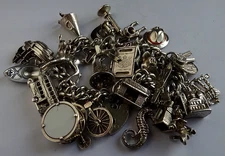 Vintage heavy solid silver charm bracelet &many curious silver charms inc moving