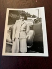 Pretty Woman Standing In Front of Old Car On Road-Photograph-08/24/45