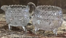 ABP CUT CRYSTAL THREE FOOTED CREAMER SUGAR ETCHED FLOWERS SCALLOPED RIM 4”T