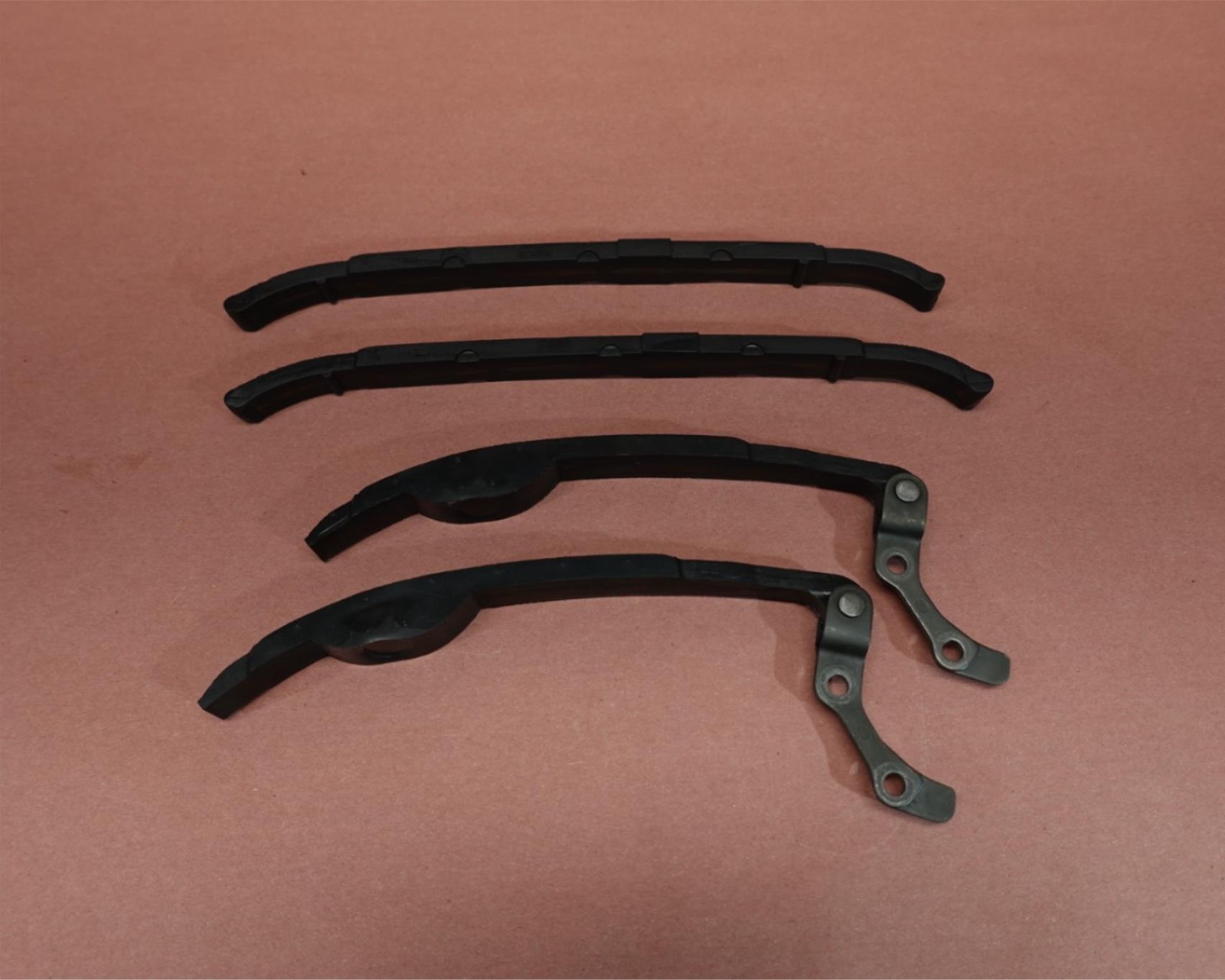Black 1998-2015 Yamaha VStar V Star 650 XVS650 cam camshaft timing chain guides with bent-over design and metal rivets.