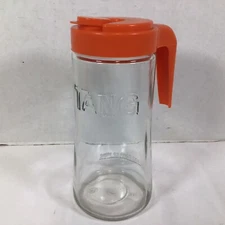 Vintage Tang Brand Clear Embossed Glass Pitcher 1 qt Orange Handle 8.5 in