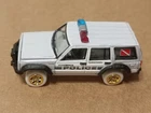 Johnny Lightning Tow & Go 2023 R2 Jeep Cherokee (XJ) 911 Police White Lightning