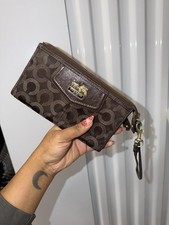 Coach Wristlet Wallet In Chocolate Brown With Monogram Logo And gold hardware.