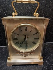 Timemaster quartz carriage clock in gold tone & floral display at the bottom