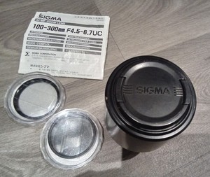 Sigma 100- 300mm F4.5- 6.7uc Zoom Lens with 2 Extra Lens Filters