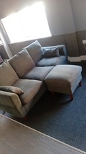 Grey sofa with footstall