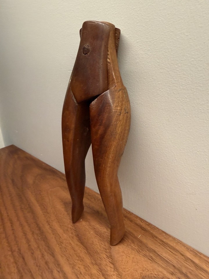 A hand-carved wooden 'naughty lady' leg nutcracker — a genuinely rare piece of figural barware folk art that's equal parts functional, cheeky, and collectible.