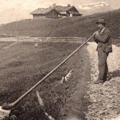 Antique RPPC Man Playing Alphorn Germany Alpenhornblaser c1900s Alps House