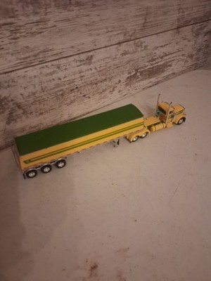 1/64 DCP GREEN/YELLOW PETERBUILT WITH TRI AXLE HOPPER