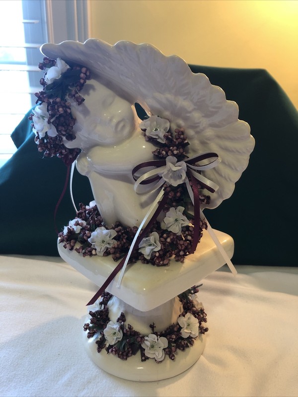 Sleeping Cherub On Base. White Flowers W/ Mauve Berries. 9 5/8” Tall & 6” Wide