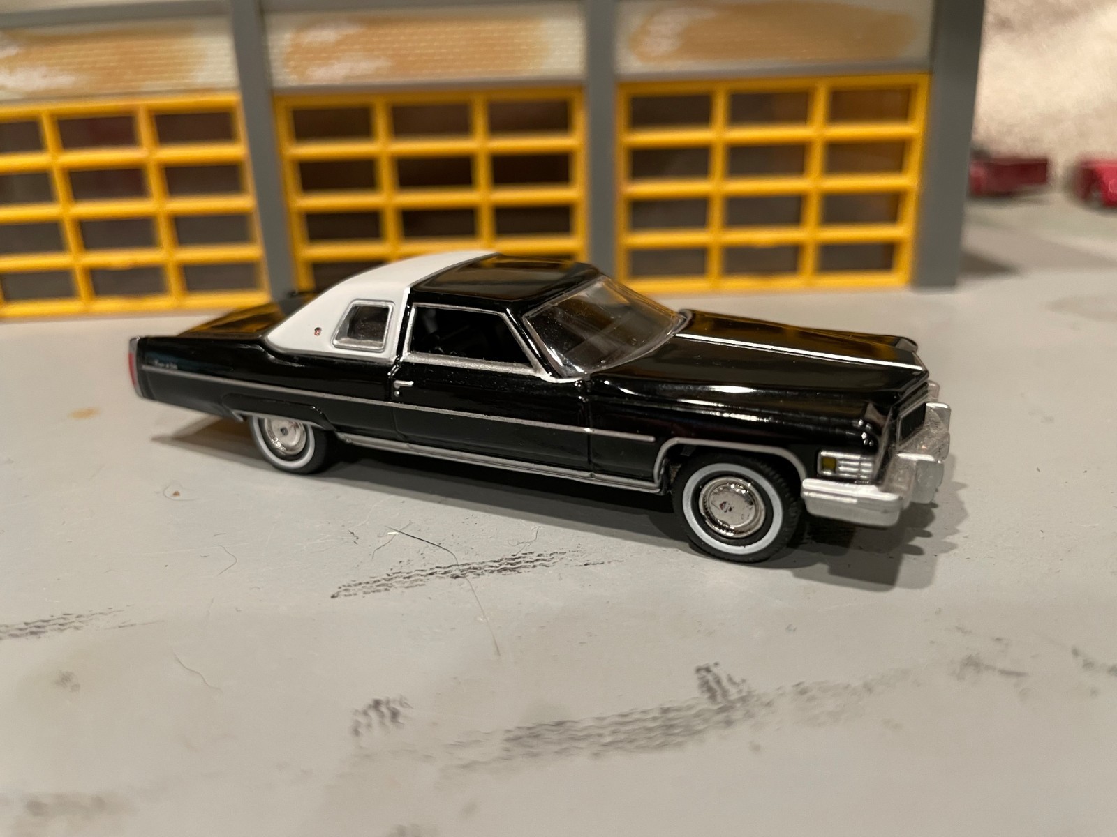 1/64 A.W. 76 CADILLAC COUPE DeVILLE/BLACK/WHITE 1/2 VINYL TOP/BLK INT/RUBBER WW