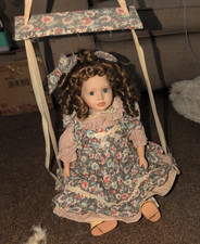 porcelain doll on a swing