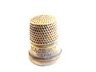 older brass colored thimble captioned "Her Majesty's Thimble England" — photo 3