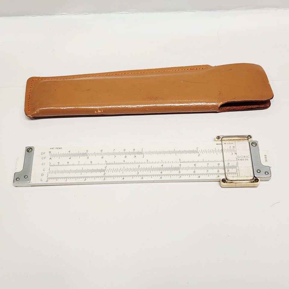 A classic K&E Doric slide rule in its original blue leather case — the pre-digital calculator of engineers and scientists, now a gorgeous desk relic.