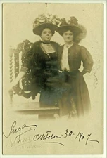 STUDIO RPPC TWO WOMAN, FUR COLOR, RUFFLES, FEATHERED HATS, 1907 FASHION
