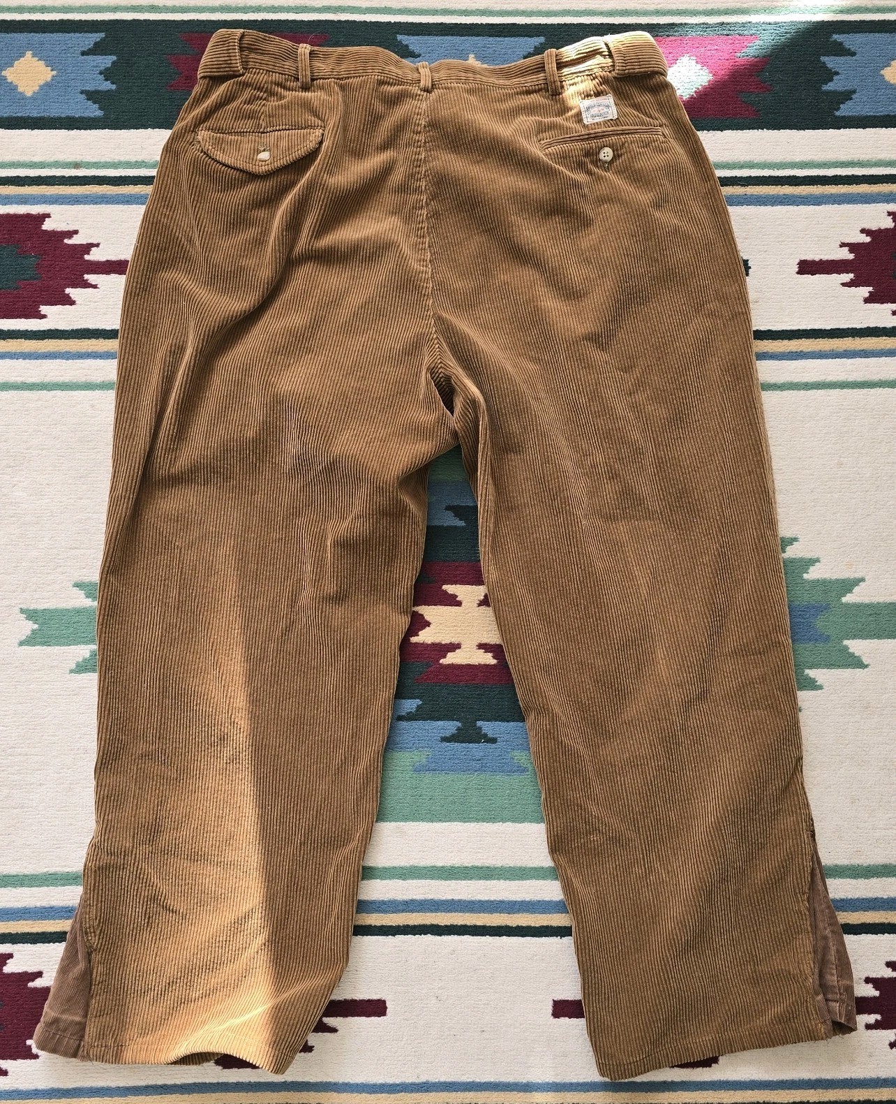 Brown 80s VTG polo cords Ralph Lauren straight-leg pants, 36x27, with button closure and belt loops on patterned rug.